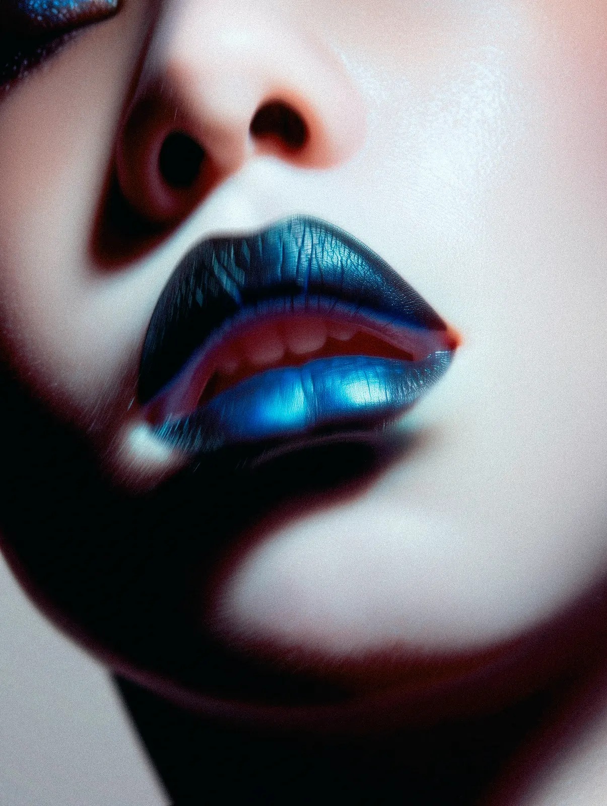 Close-up of glossy dark lips and the lower half of a face.