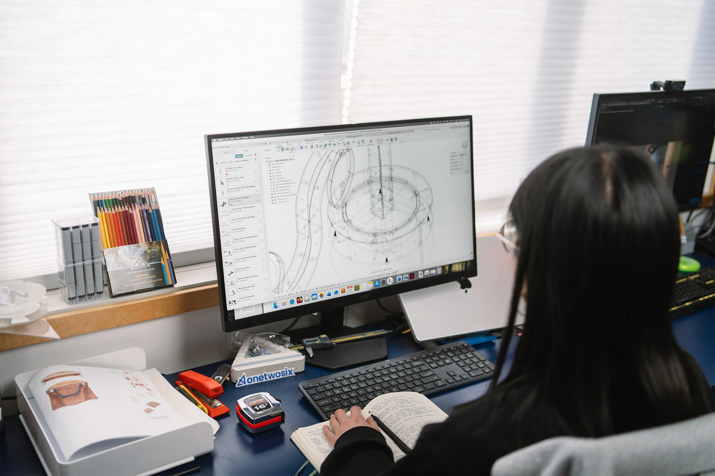 A lady works on a file in CAD software
