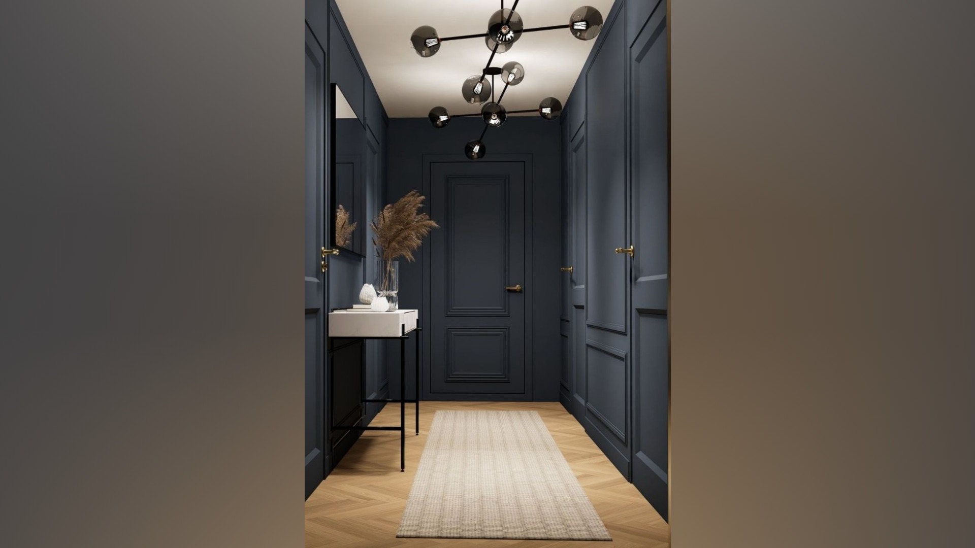 Deep navy wainscoting and brass hardware define this dramatic Mount Pavilia entryway featuring a minimalist white console and geometric sphere chandelier.