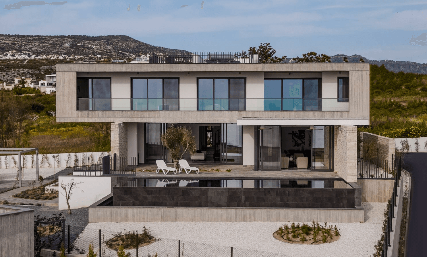 birds flying above white and gray house during daytime