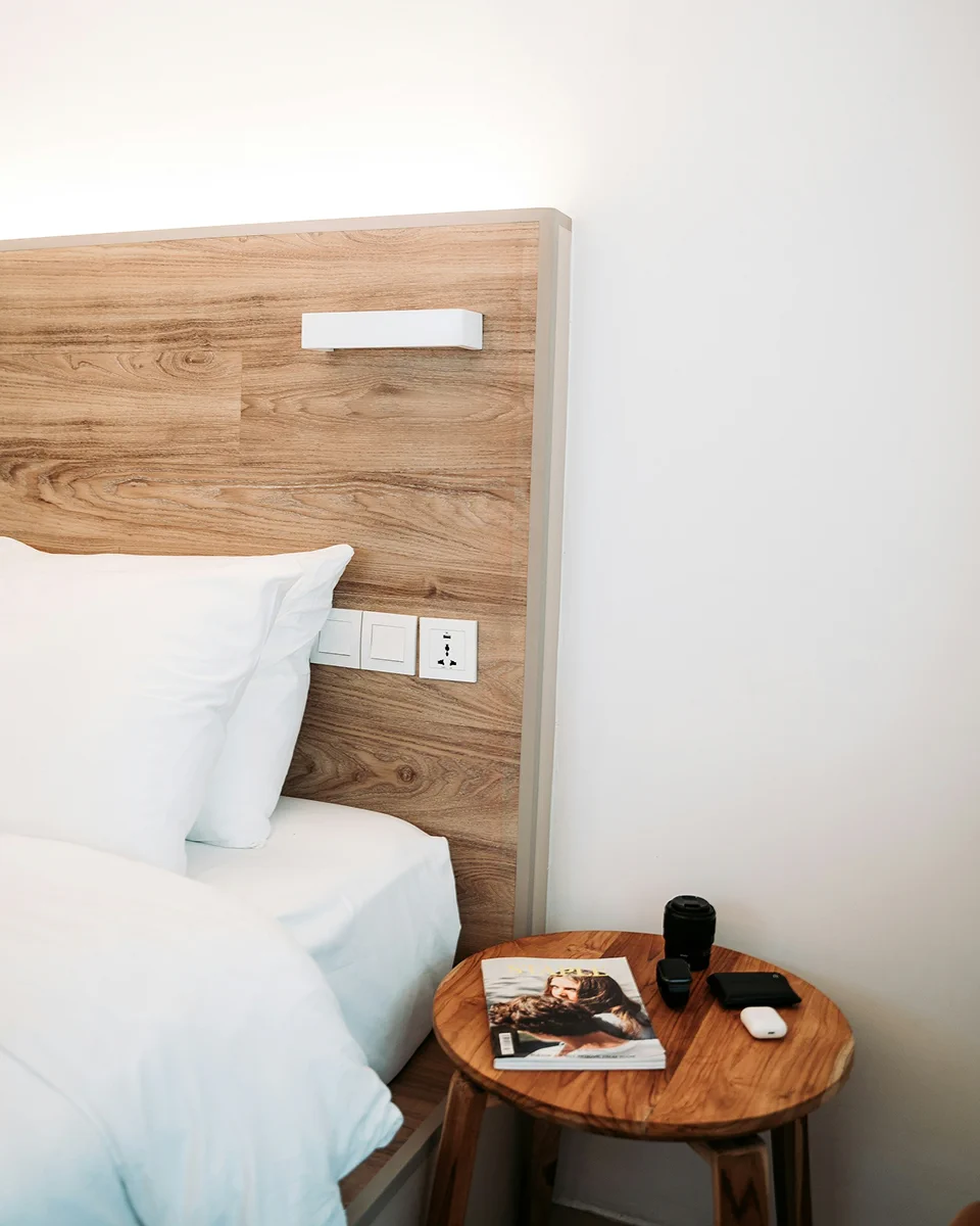 Hotel bed and bedside table with coffee.
