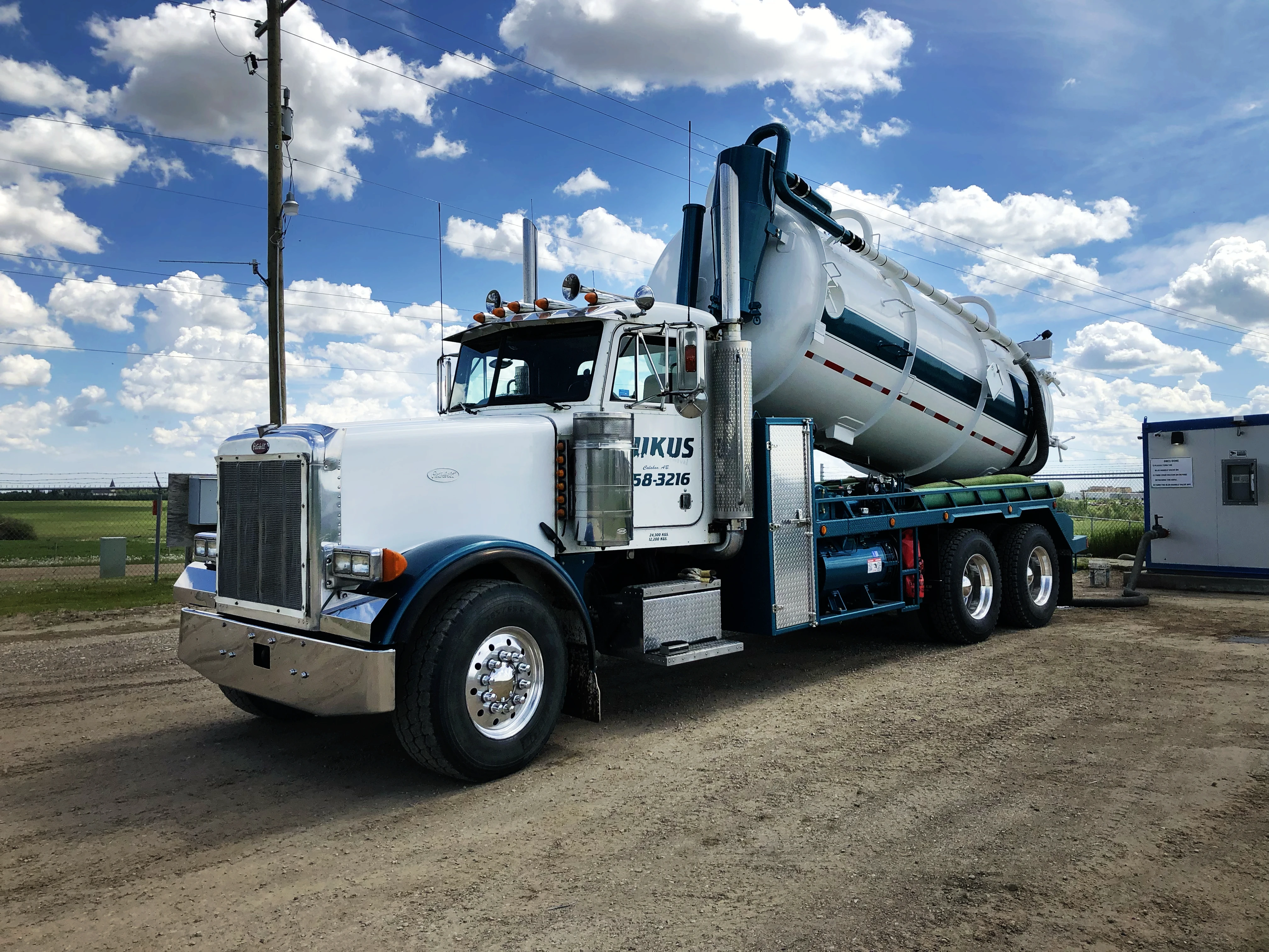 Rukus Liquid Waste Removal vacuum truck on-site in Alberta, providing industrial waste management and grease trap cleaning services for Edmonton businesses.
