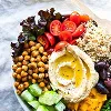 Mediterranean-style foods including vegetables, fruit, whole grains, olive oil, nuts, seeds, fish, and legumes.