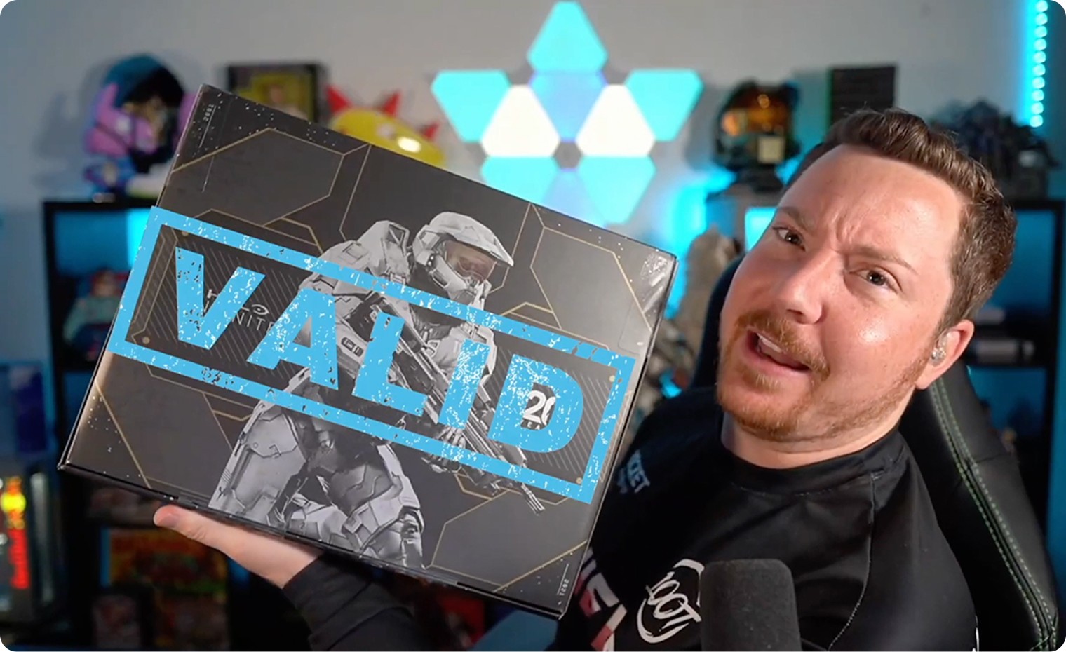 SnowBikeMike holding up Halo Infinite Limited Edition packaging with a stamp that says "Valid"