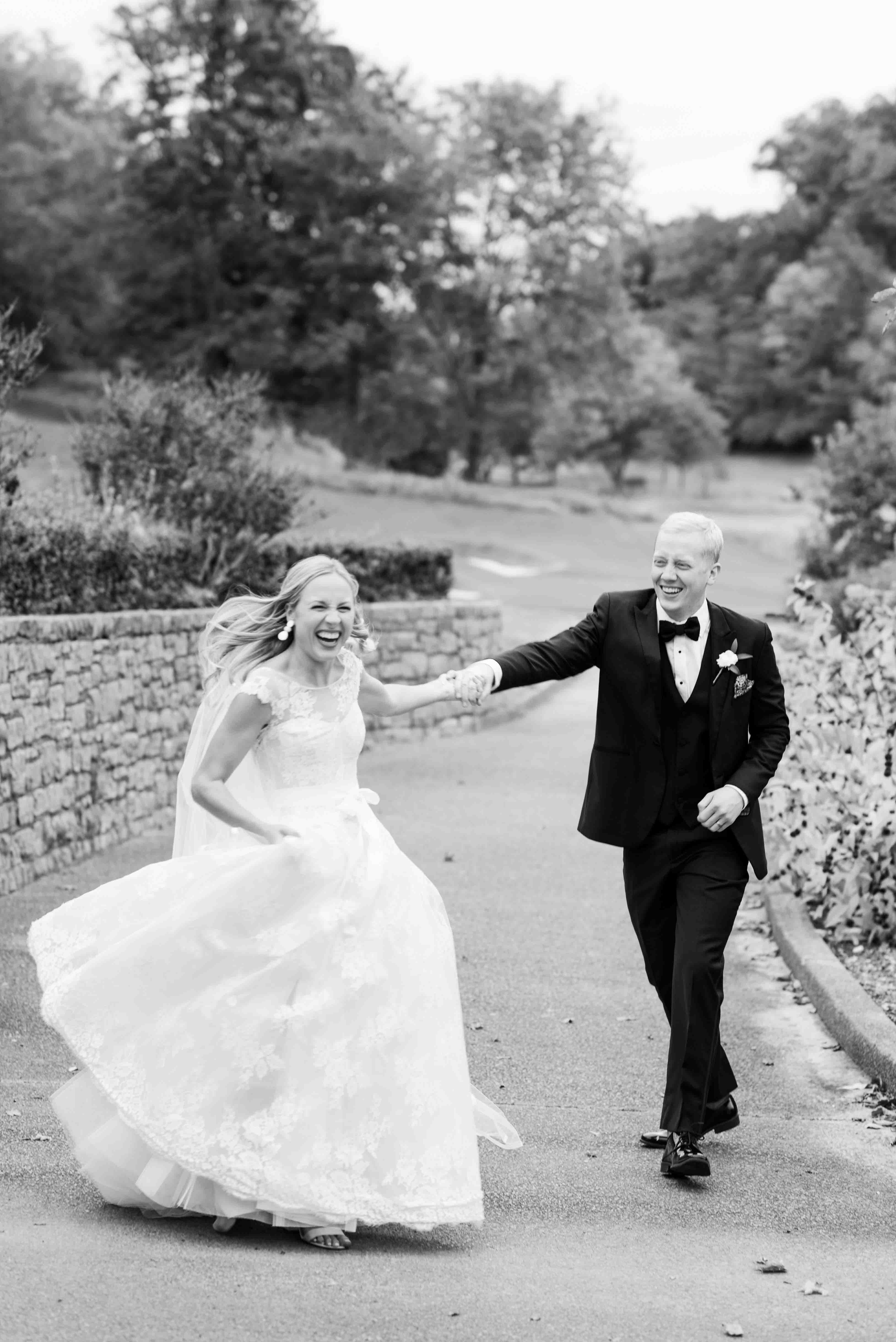 Bride and groom running and laughing at Richland Country Club