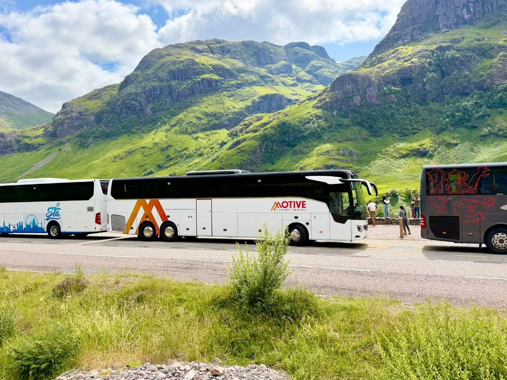 Luxury coach and minibus fleet used for city tours and private transfers, showcasing premium travel services and modern design in urban and scenic environments