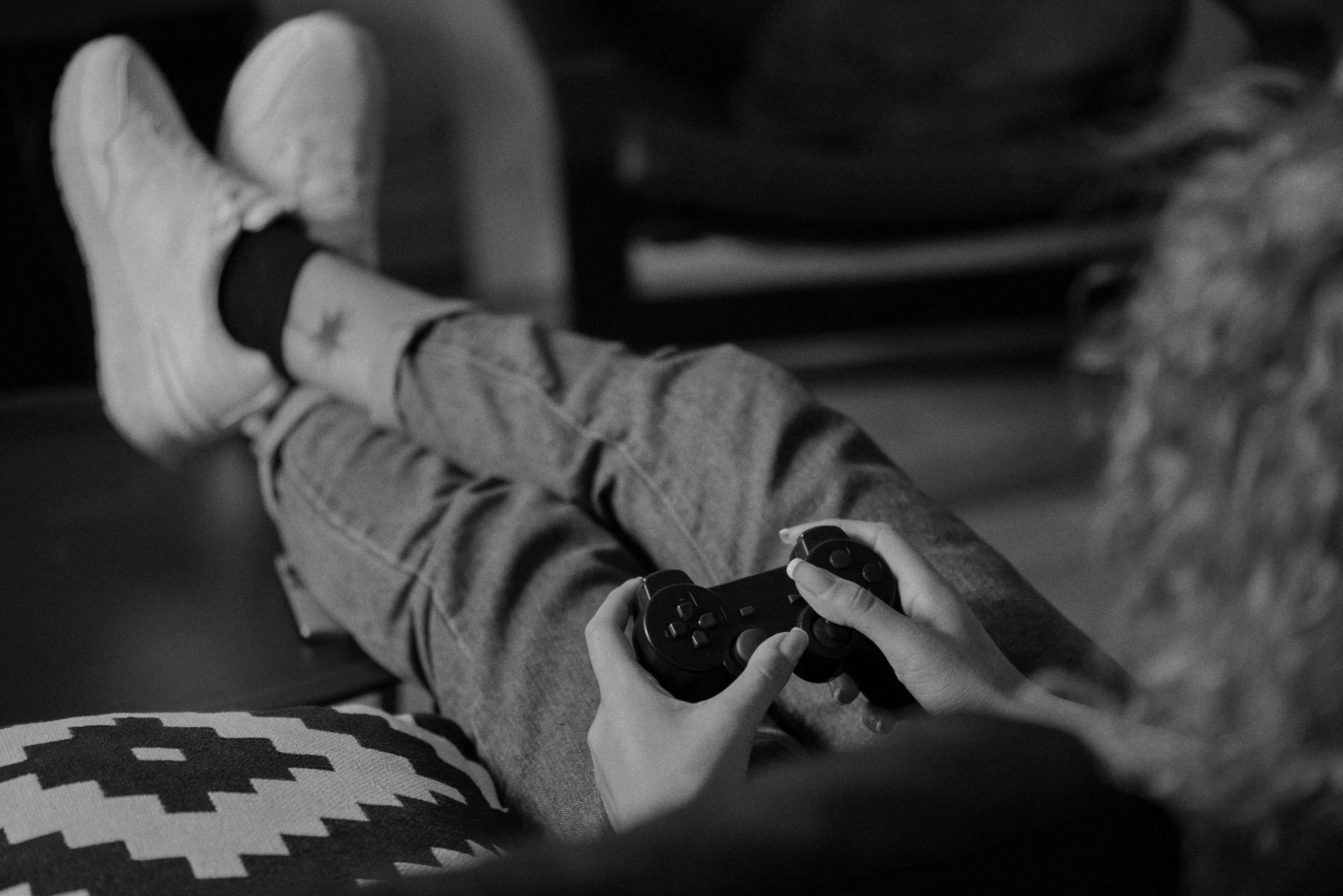 Woman with curly hair playing Playstation