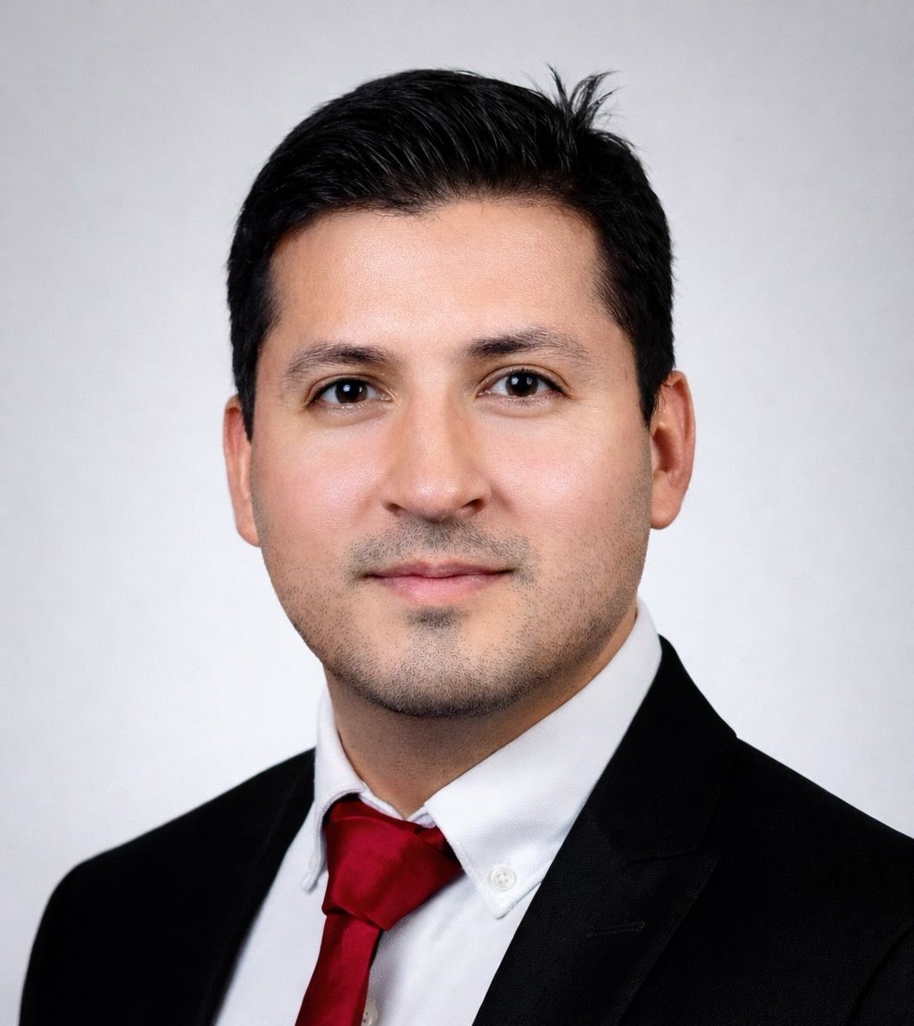 a man in a suit and tie sitting in a chair
