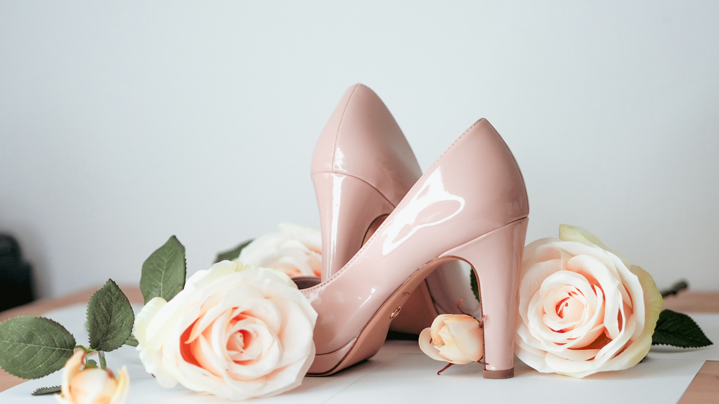 female heels between roses - Shoe Product Photography