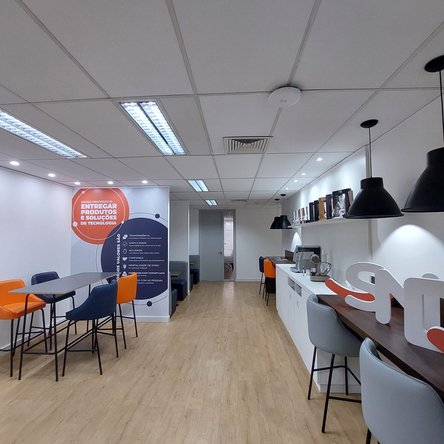 Contemporary interior with sculpted angled walls and a skylight filling the space with natural light.