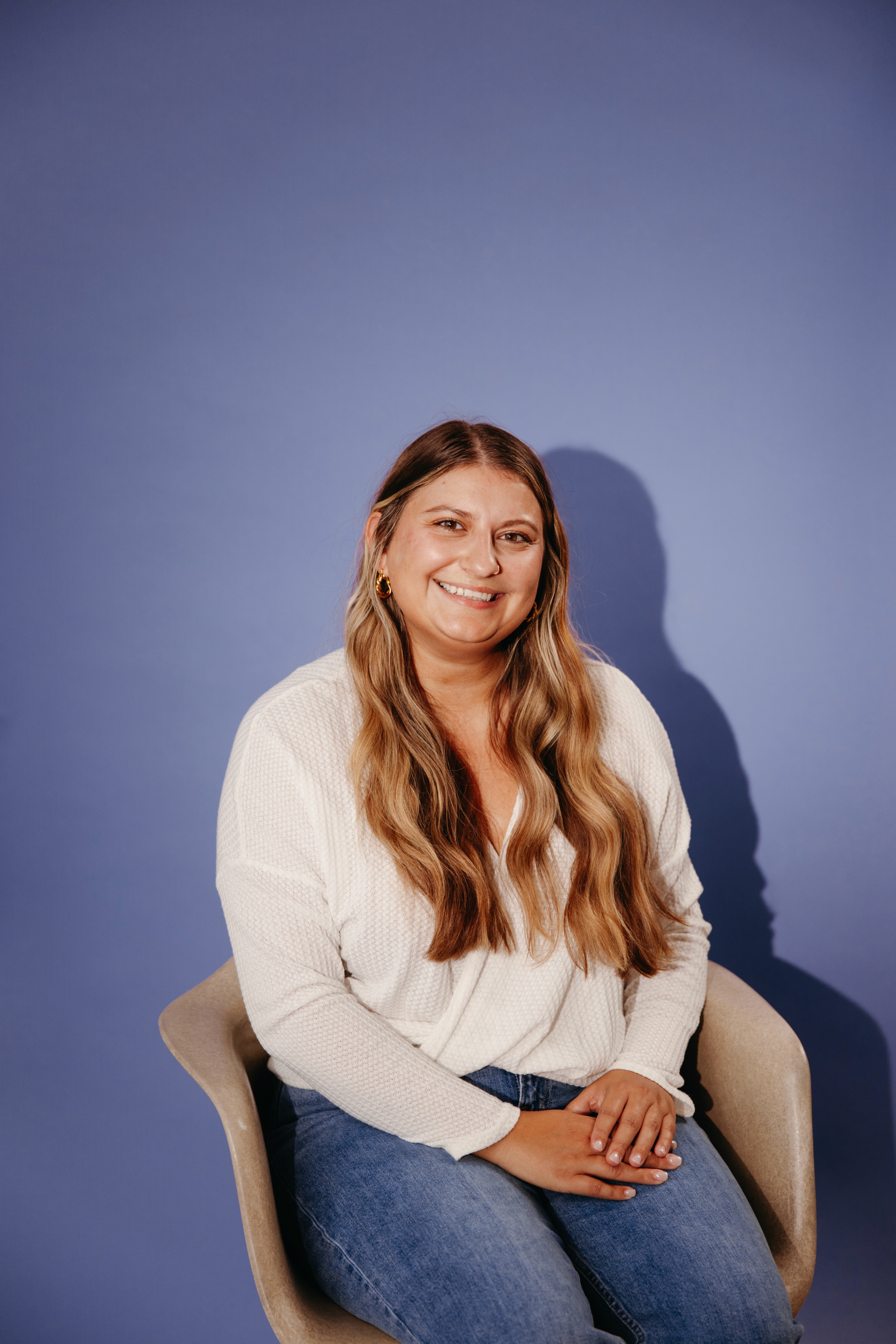 Headshot of Ashley on a purple backdrop