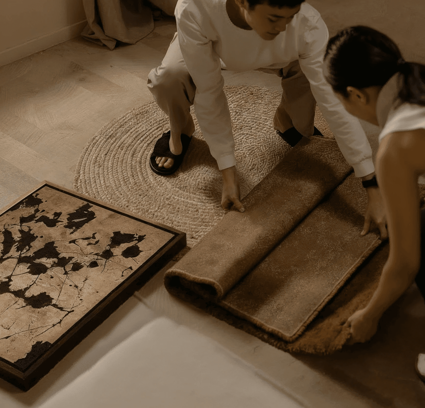 A scene of two ladies unfolding a floor mat