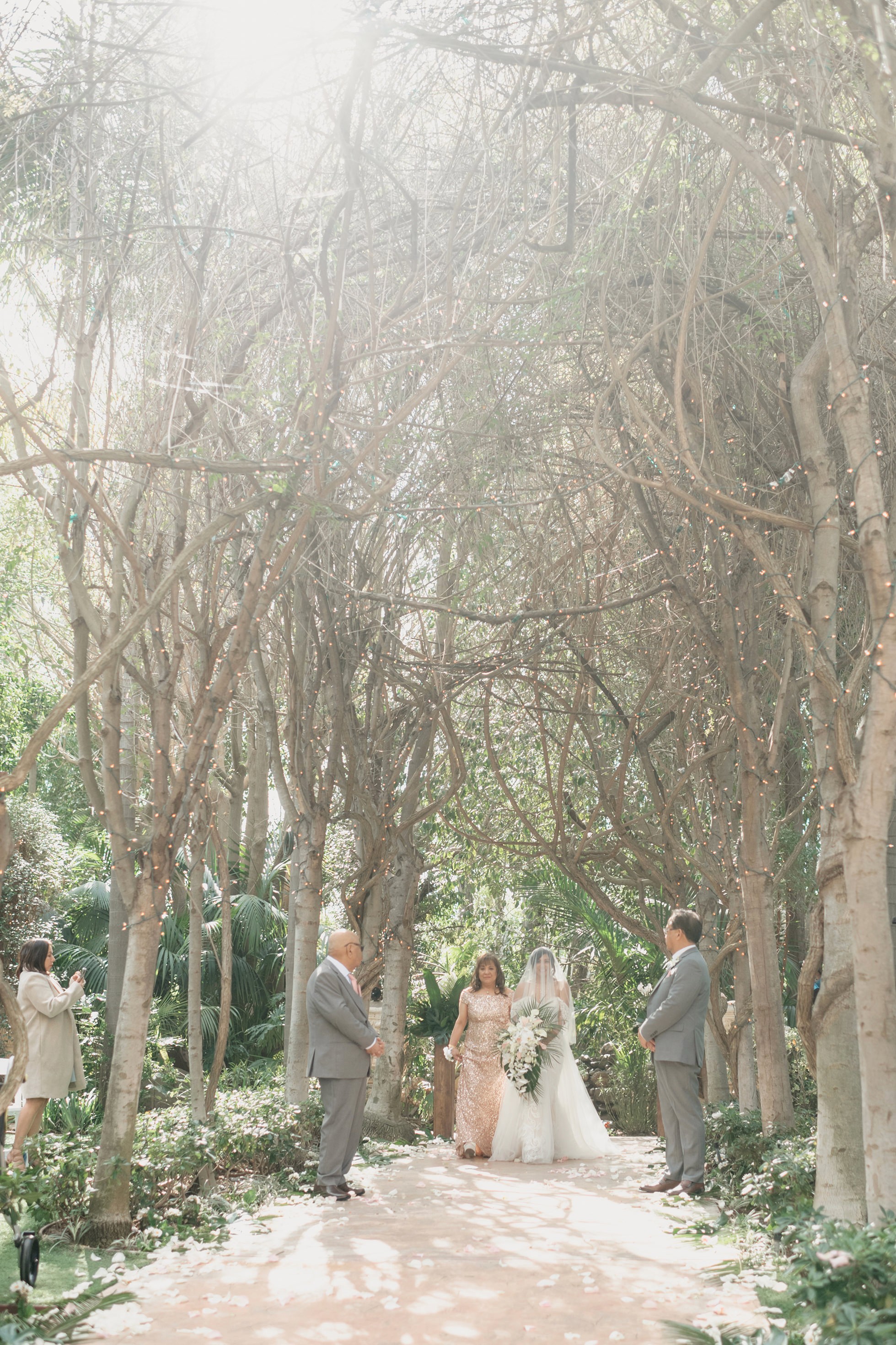 Bride walking down the aisle at outdoor garden ceremony