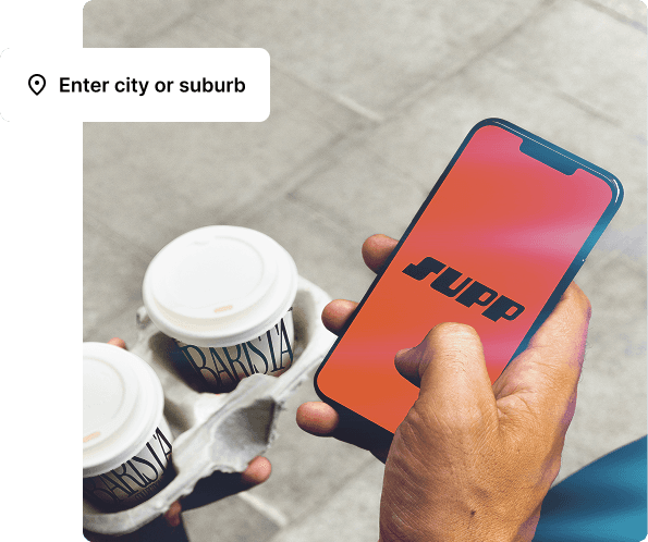 Holding the Supp app and a tray of takeaway coffees, with a location search prompt