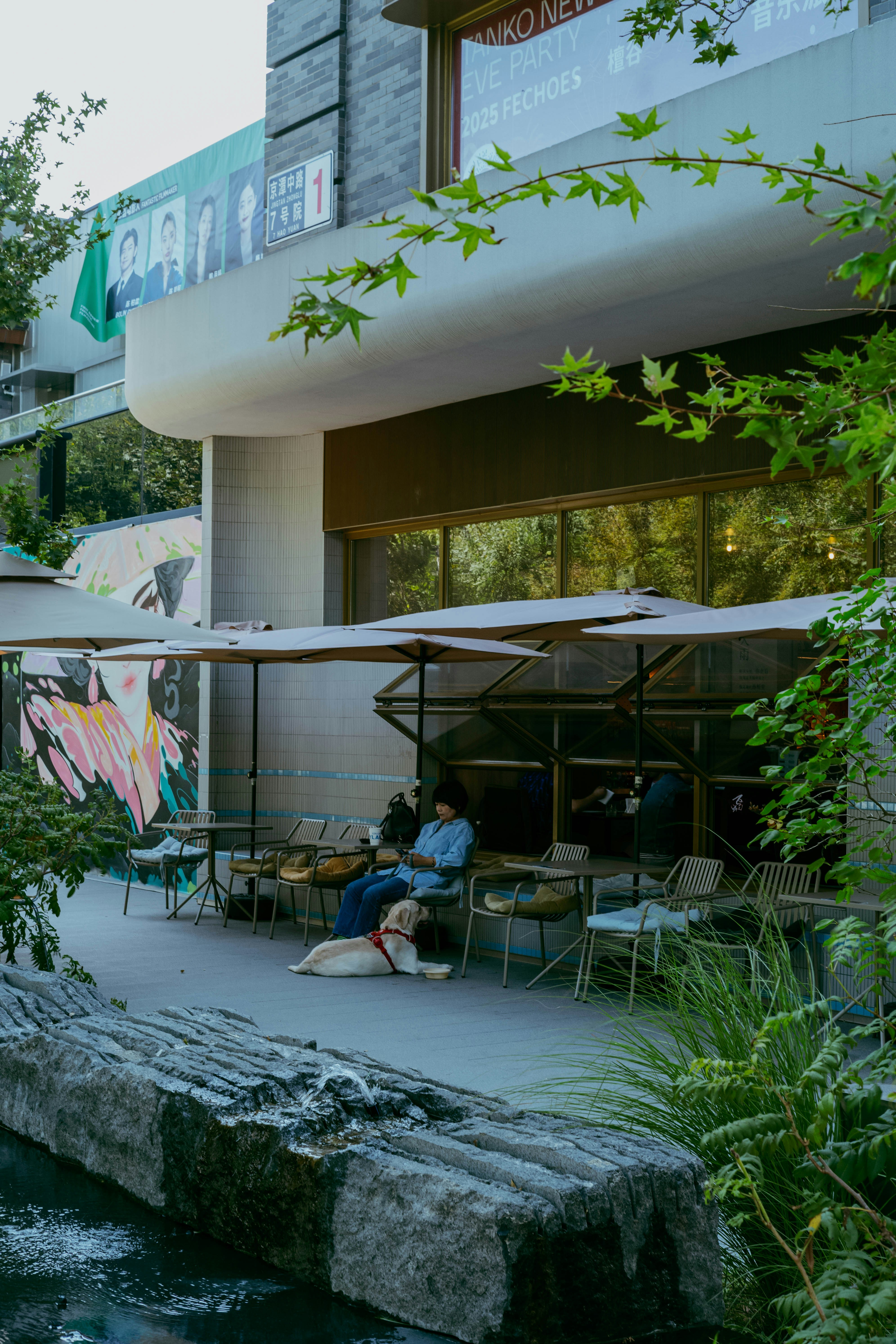 Person and dog relax at outdoor cafe seating
