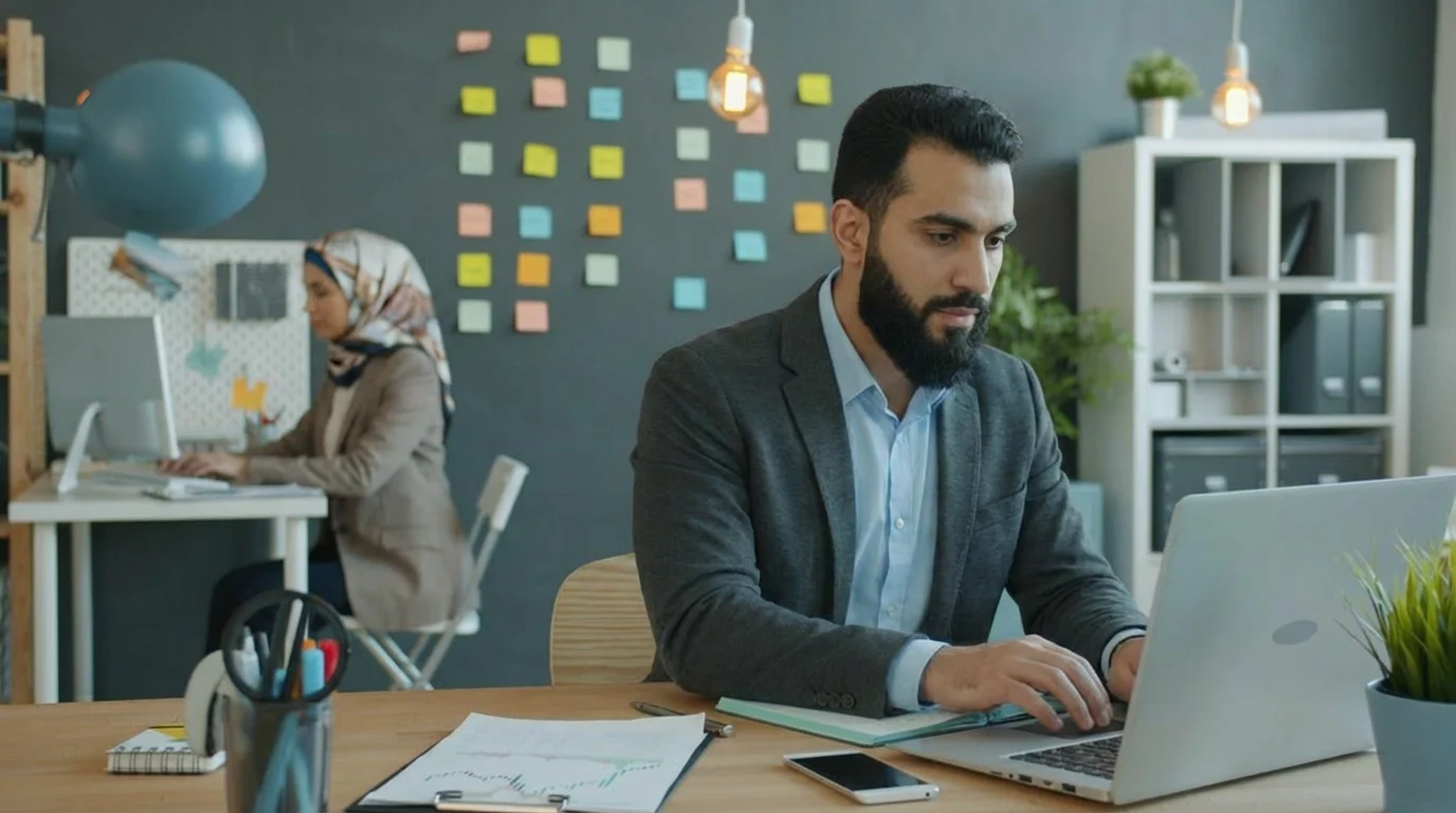 A dedicated Muslim web developer and SEO specialist working at their desks on a custom website project for a Halal brand client.