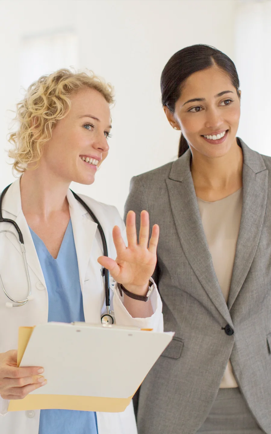 Doctor and Filipino nurse reviewing chart.
