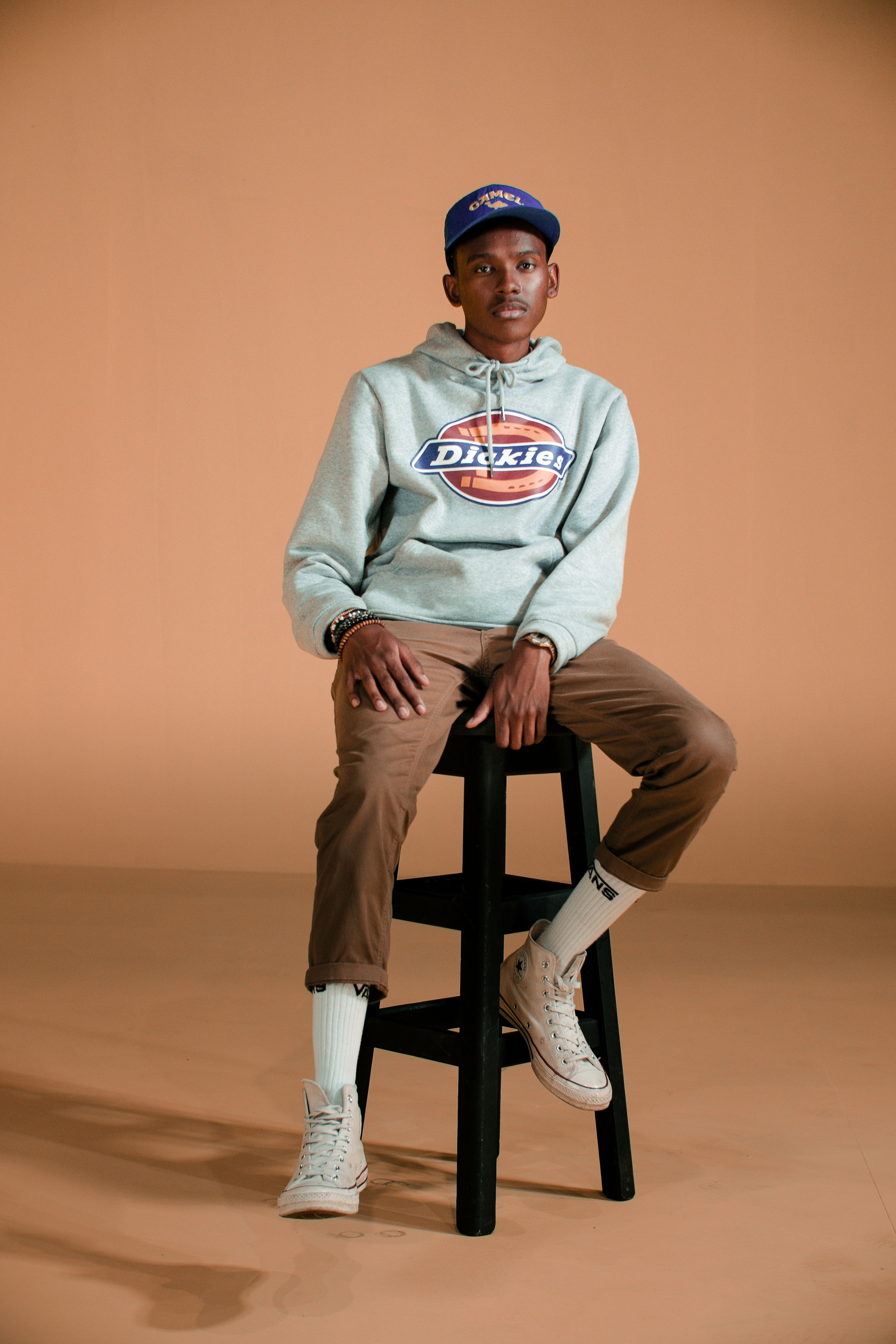 man in gray pullover hoodie sitting on black seat