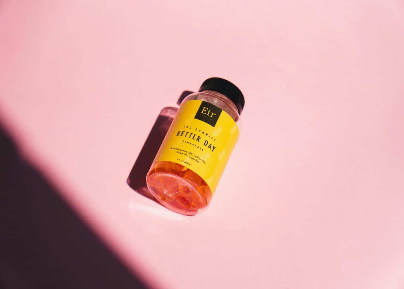 couples libido gummies in a container on a yellow background