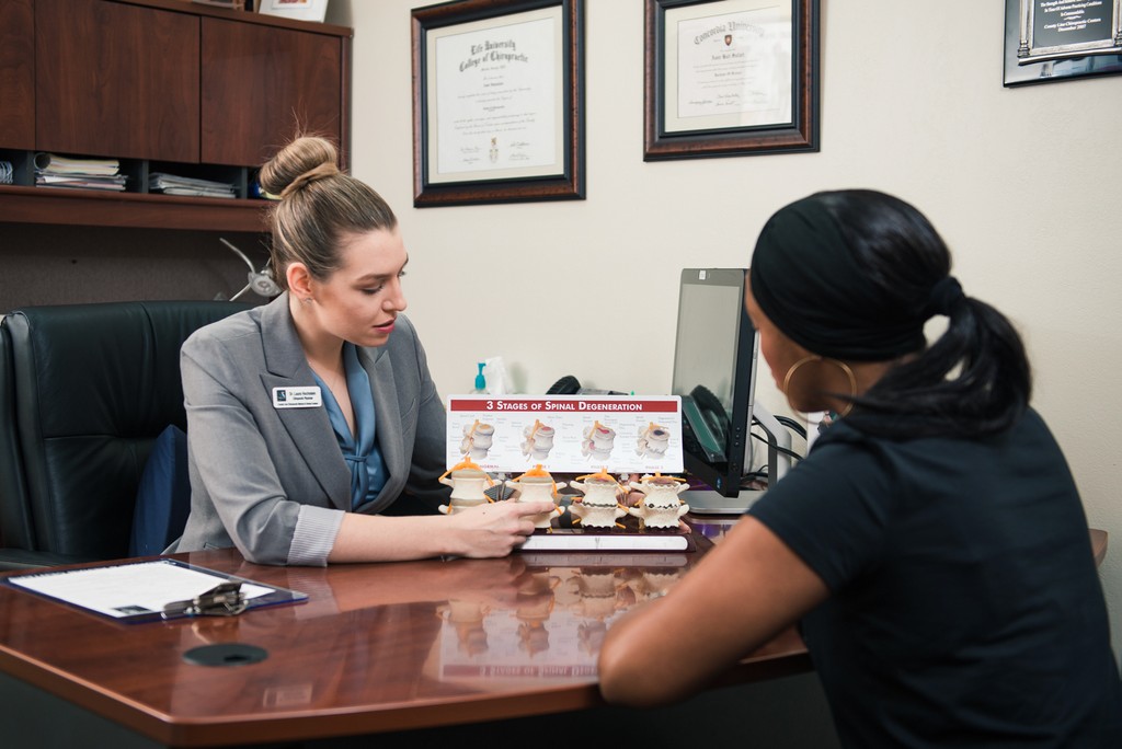 dr laura showing diagrams to a patient