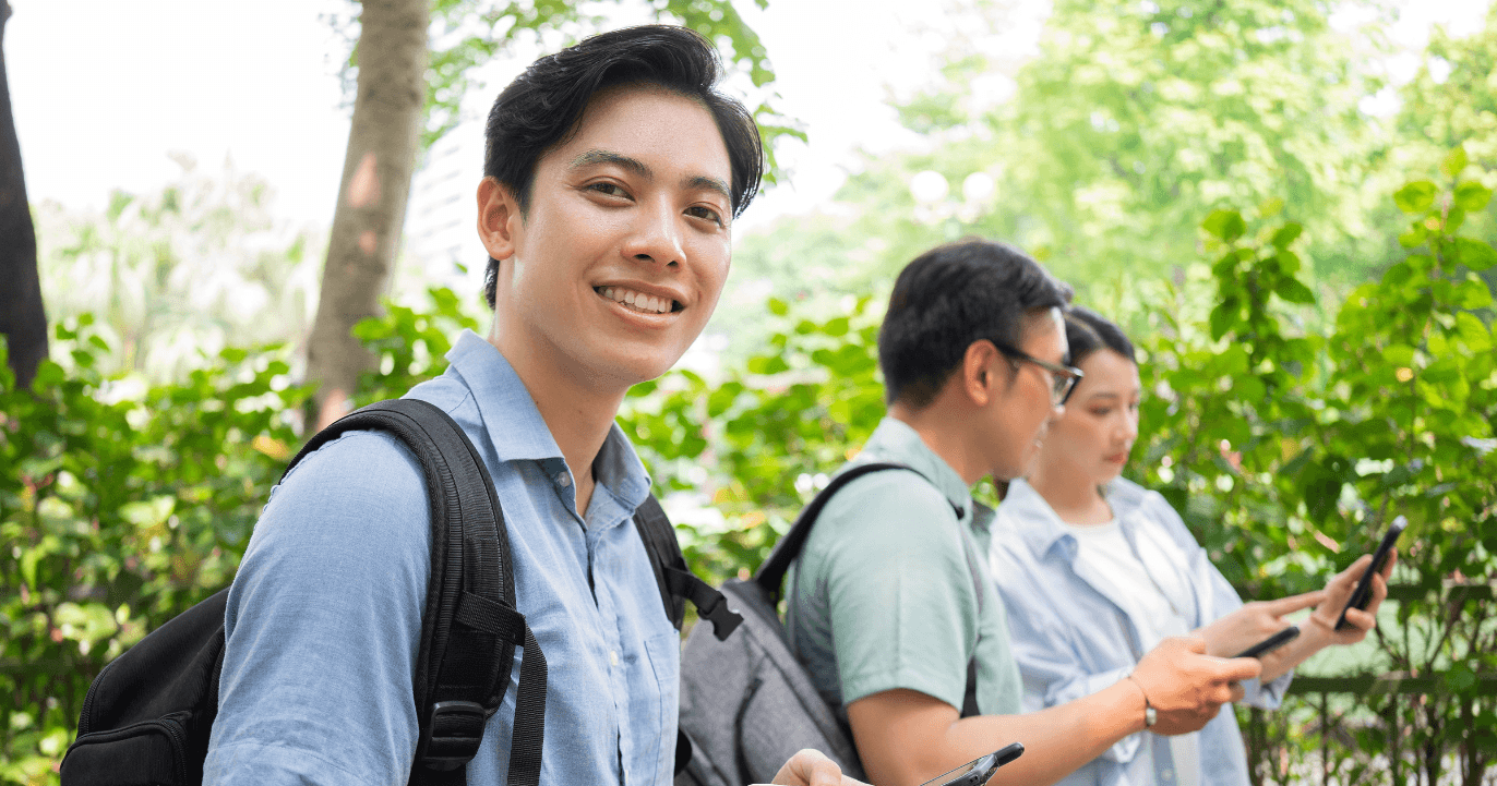 A man and a woman looking at a model of a skeleton