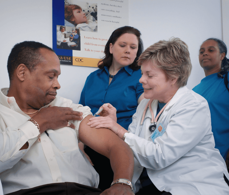 A woman sitting on a couch with a laptop