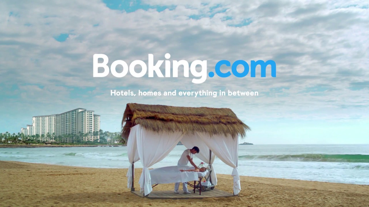 Massage table on the beach featuring the Booking.com logo