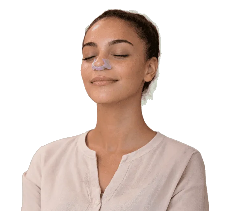 Woman wearing StillPoint device with eyes closed meditating.