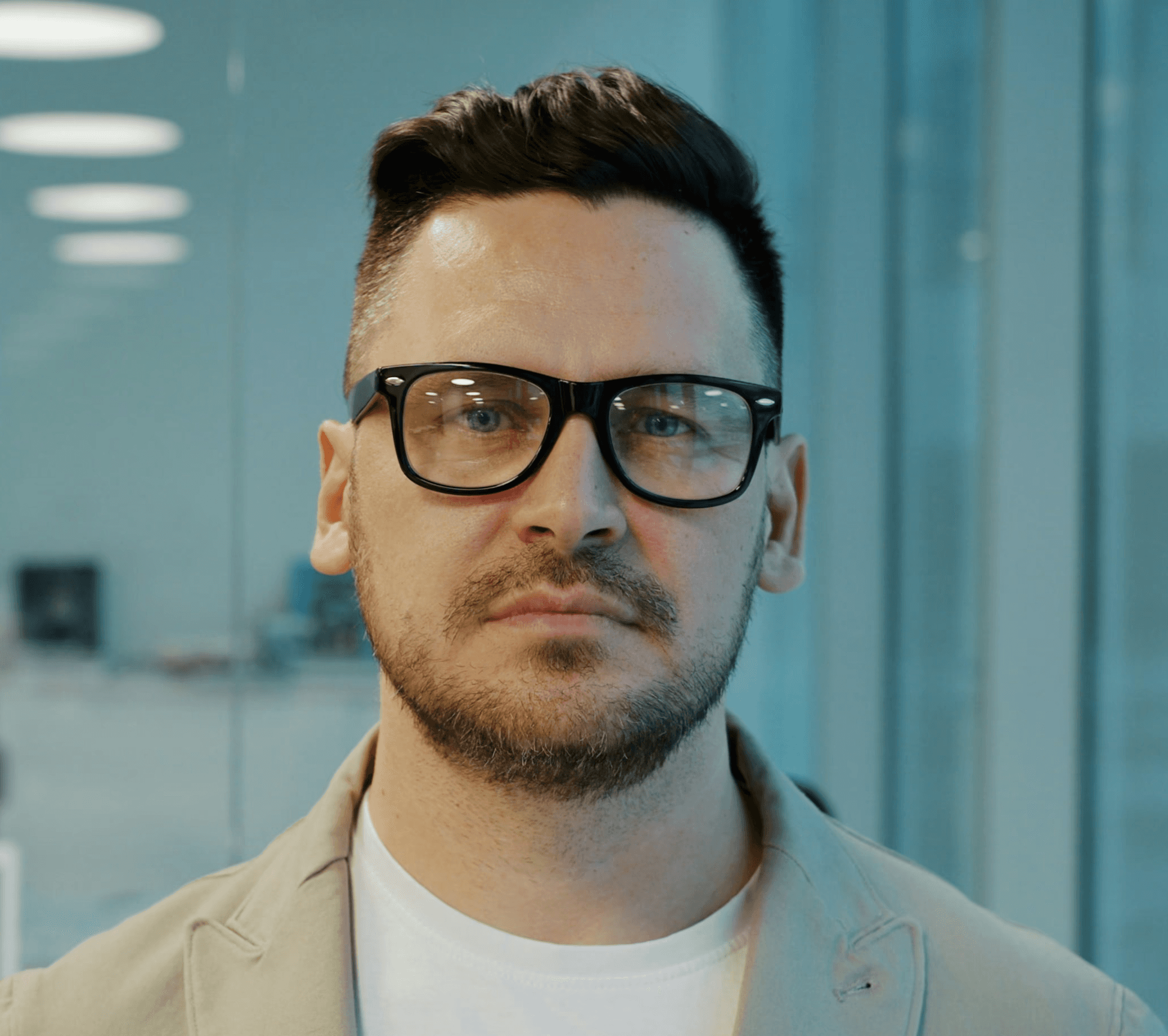 Man with glasses in a modern office setting