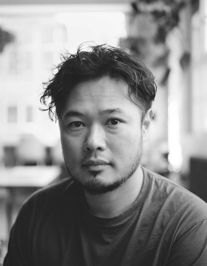 a blurry photo of a person standing in front of a wall