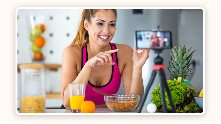 Smiling food influencer filming in her kitchen
