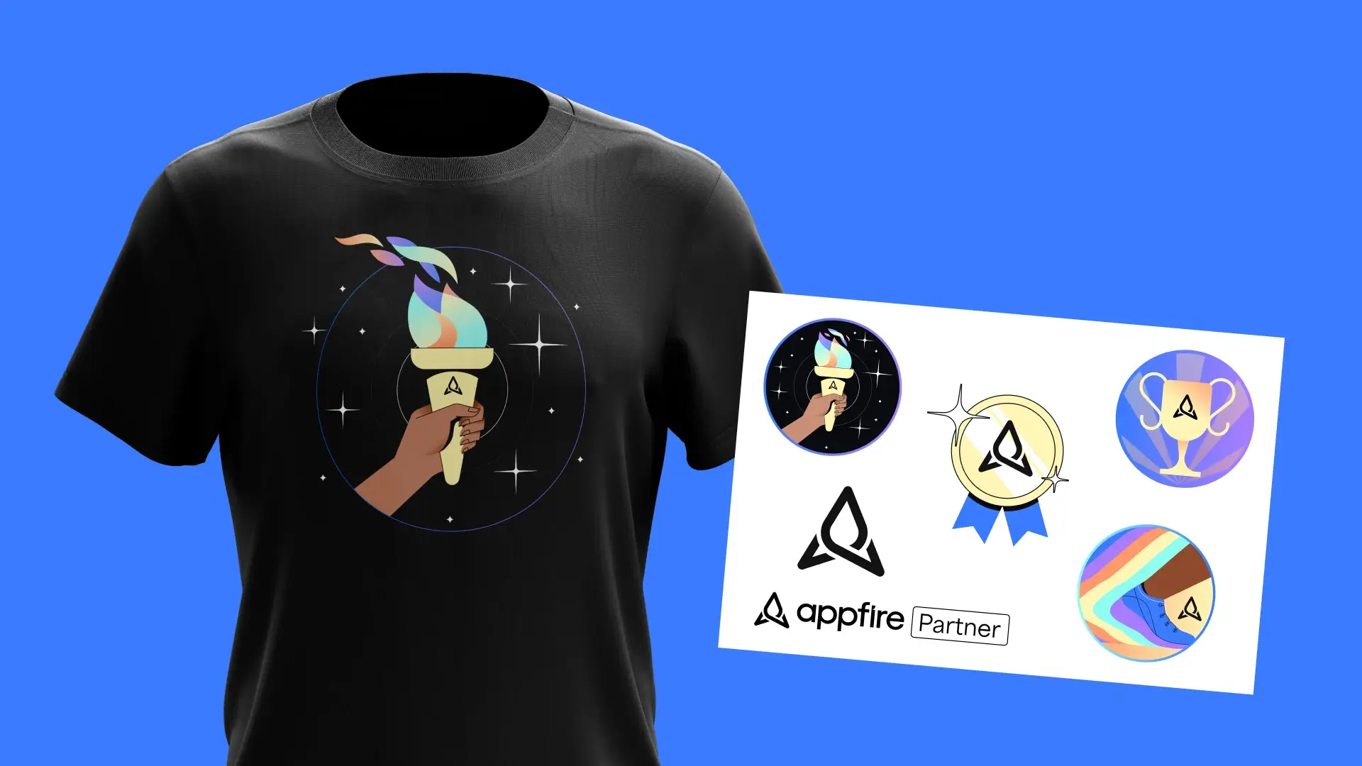 A black T-shirt displays a hand holding a colorful torch, surrounded by stars. Nearby, a sticker sheet sheet shows various Appfire-themed icons and logos against a blue background.