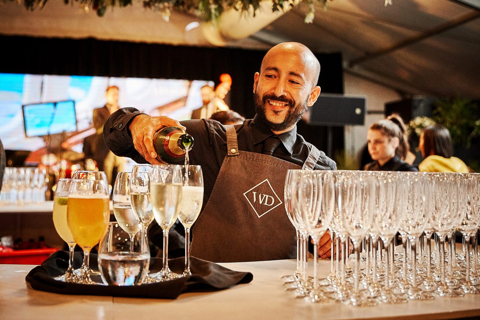 Bartender pouring champagne on arrival
