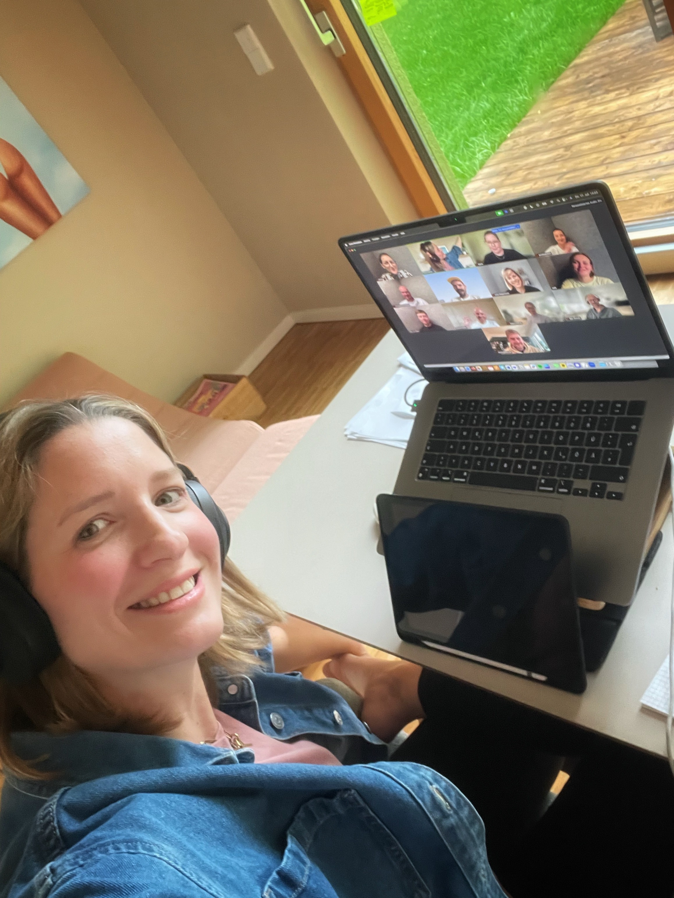 A young man with dark hair smiles at the camera, set against a modern indoor background.