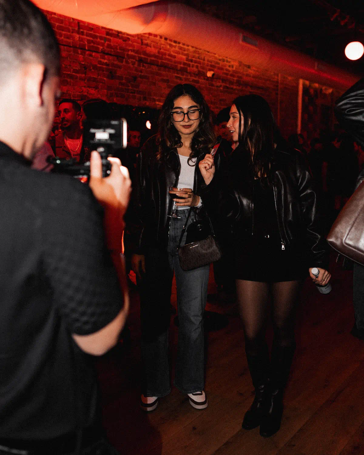 a group of people in a room with red lights
