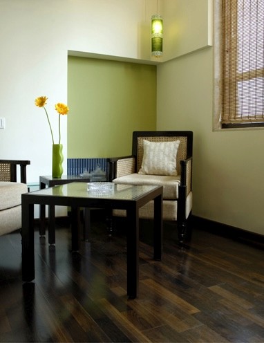 Nature-inspired preschool entrance with sculptural tree partitions and suspended green leaf ceiling panels.