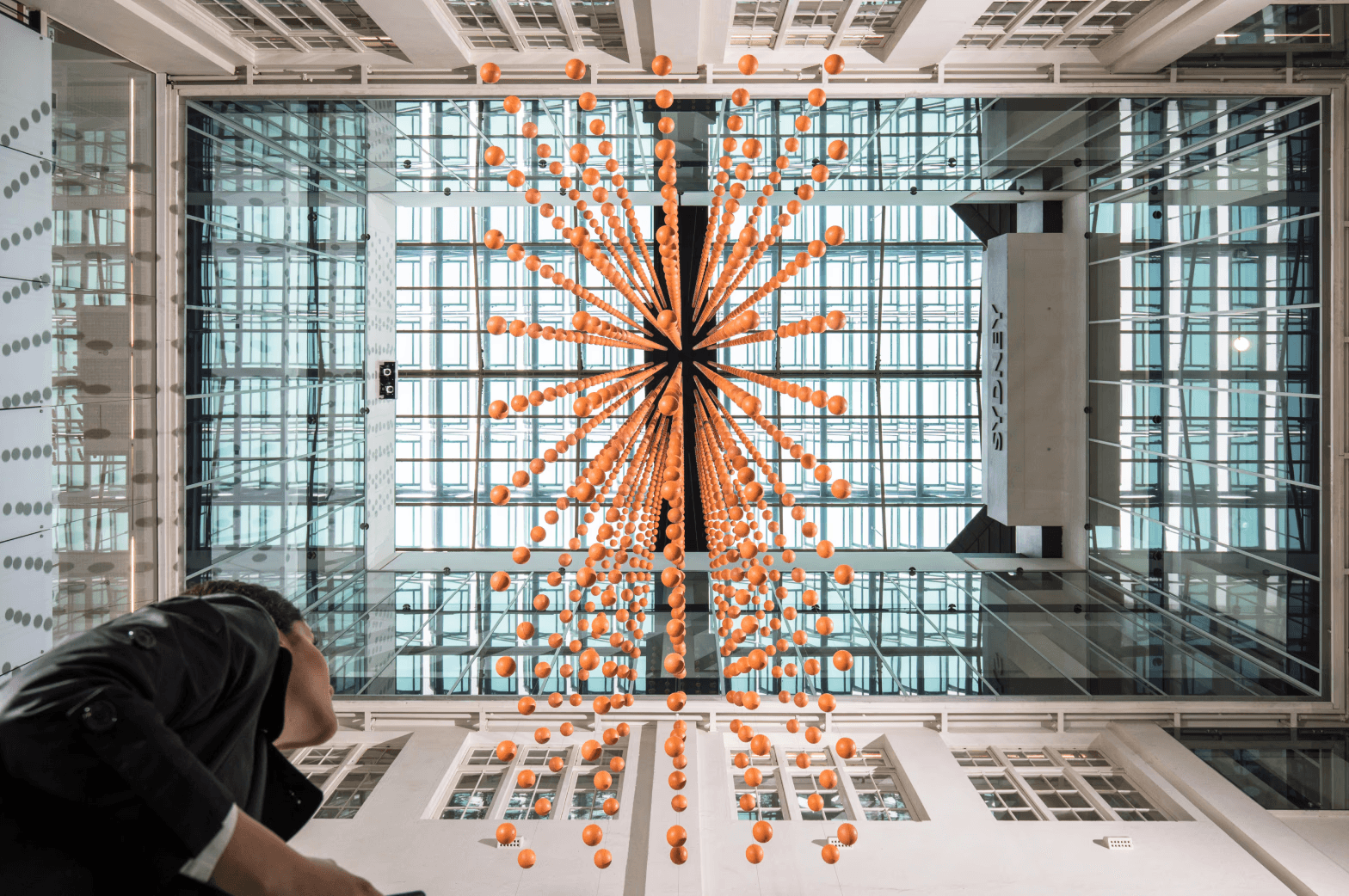 Wasteland, an installation of suspended orange spheres in a Sydney atrium, created by Danling Xiao for Mundane Matters. Photo by Katherine Griffiths for City of Sydney.