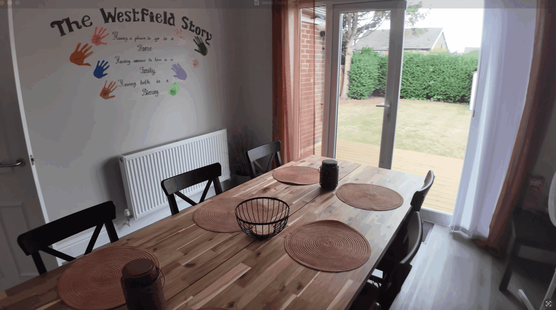 person in gray hoodie holding red and white box