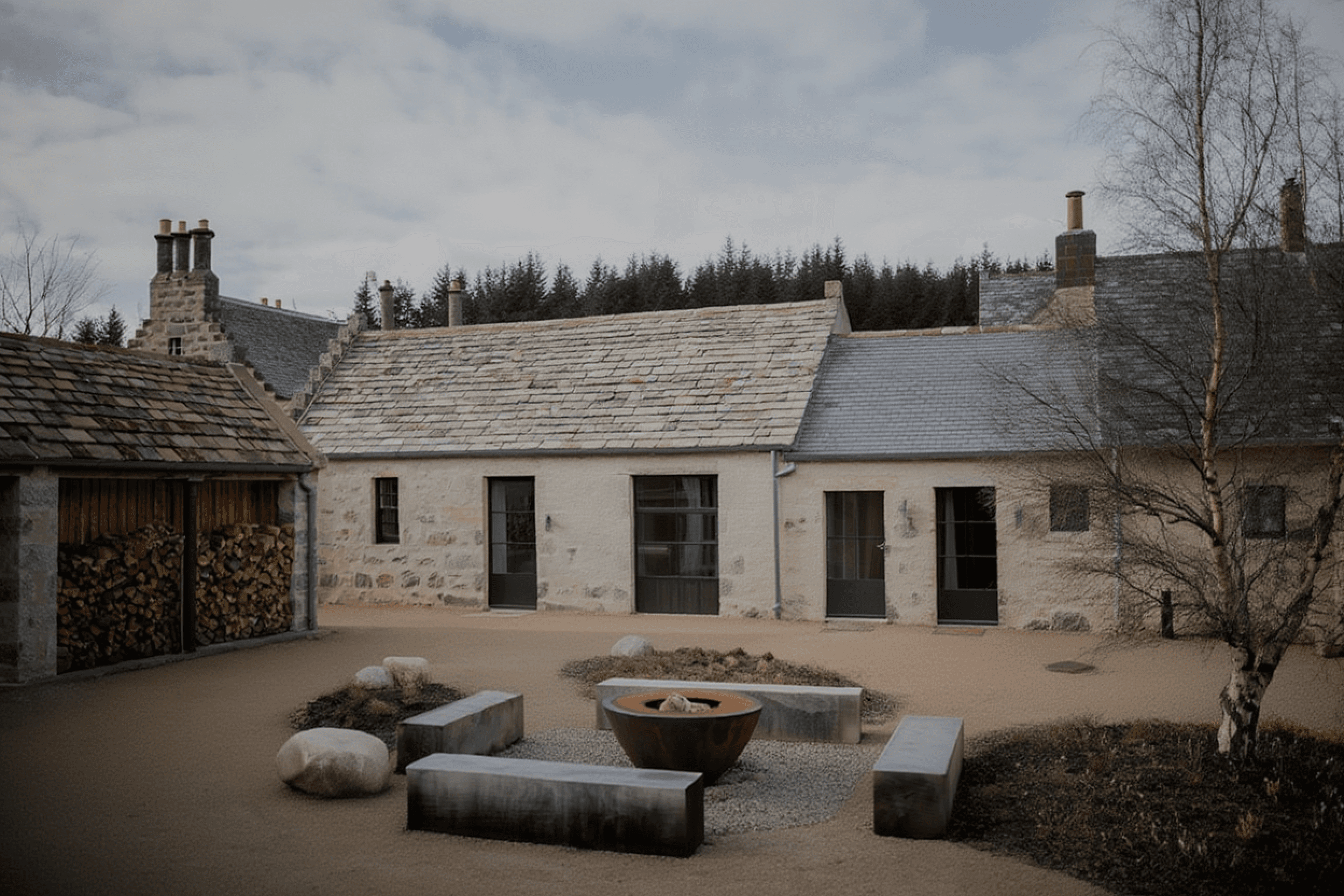 Stone cottage with slate roof set in open countryside landscape