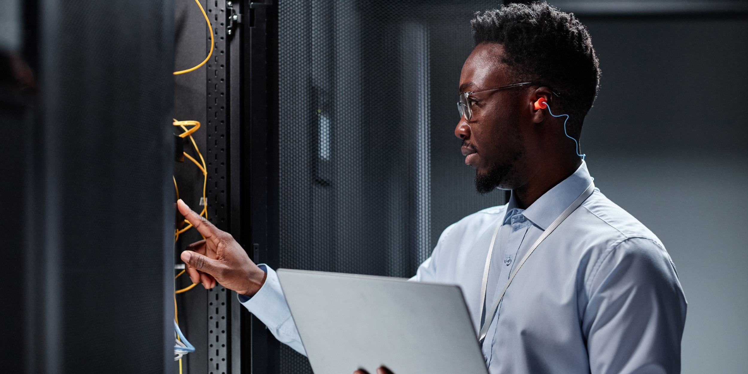 Red digital warning symbol glowing on a circuit board interface, representing active ransomware exploitation of the VMware ESXi CVE 2025 22225 vulnerability and hypervisor compromise.