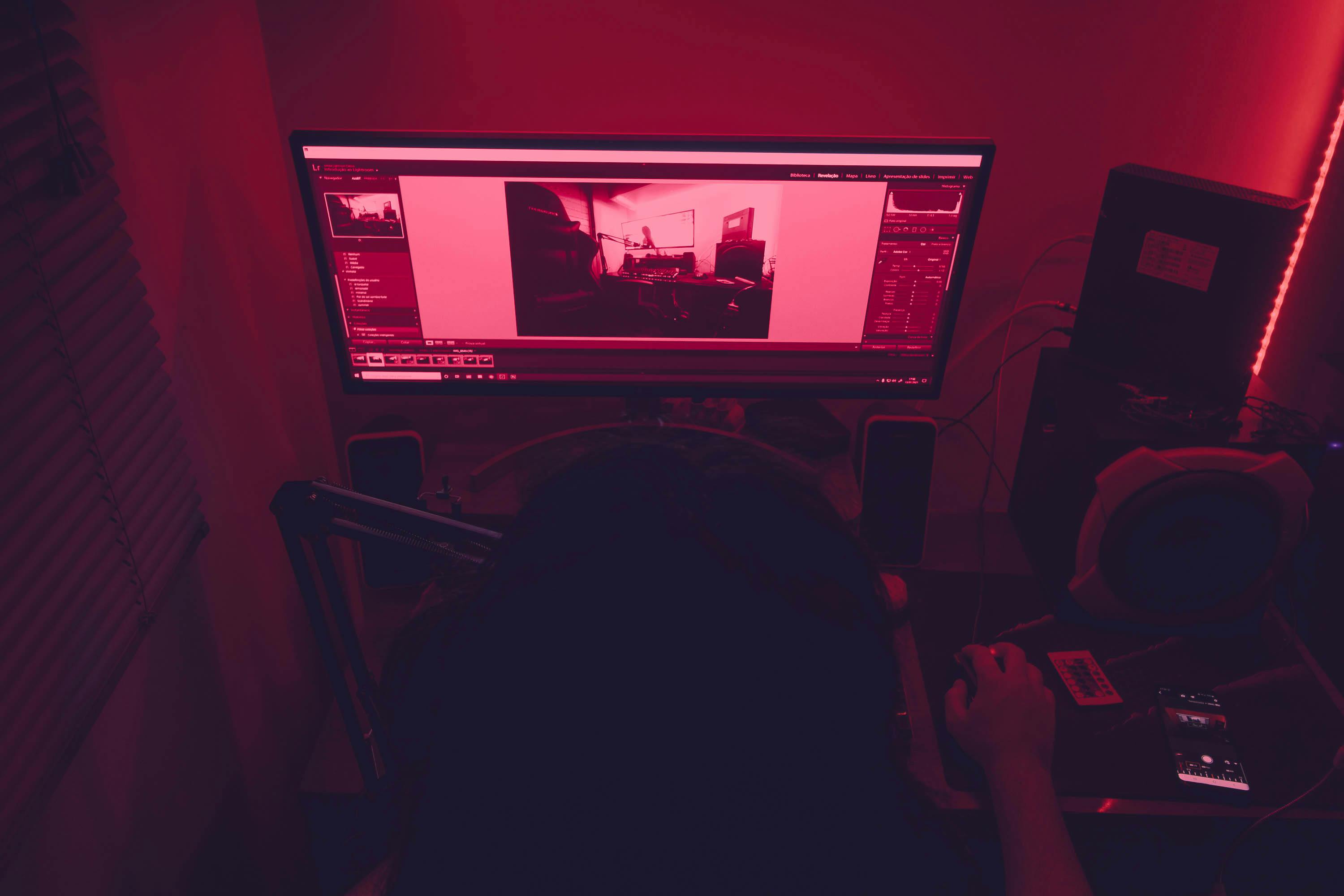 a-red-illuminated-desk-setup-with-a-man-working-on-a-computer-at-night,-featurin - maurício-mascaro (pexels)
