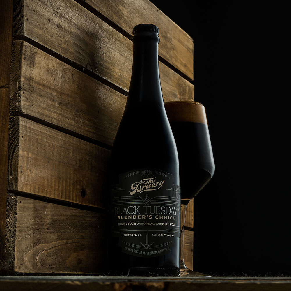 Black Tuesday bottle against wood background