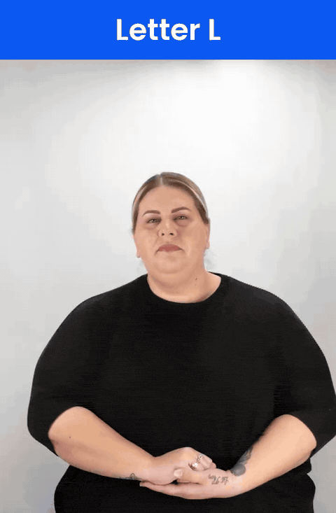 Animated GIF: a Deaf signer signs L in ASL, the index finger and thumb making an L.