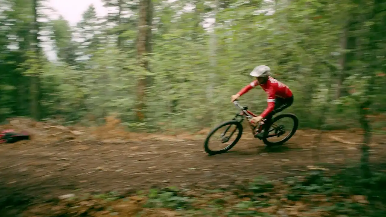 Whip pan shot with a lot of motion blur of a mountainbiker