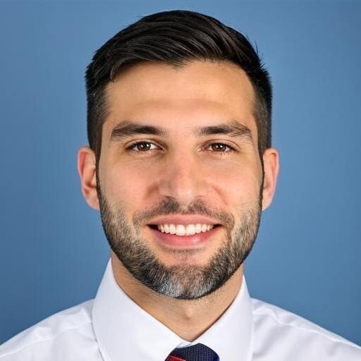 a young man wearing glasses standing in front of a mountain