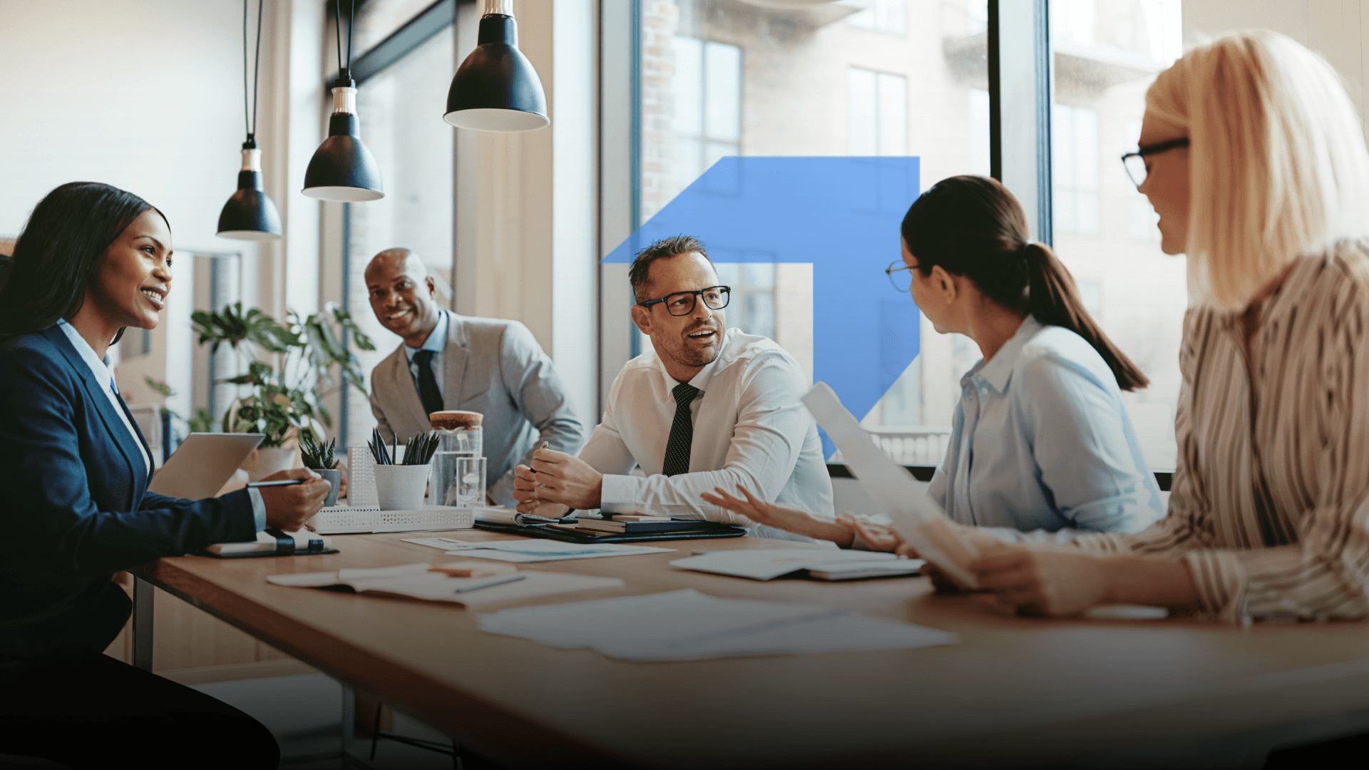 A group of people in an office setting discussing 
