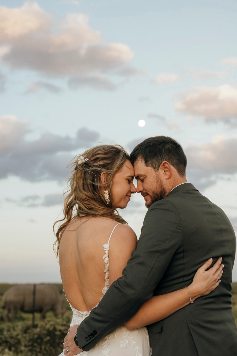 Bride and groom under moonlight during cinematic evening portrait