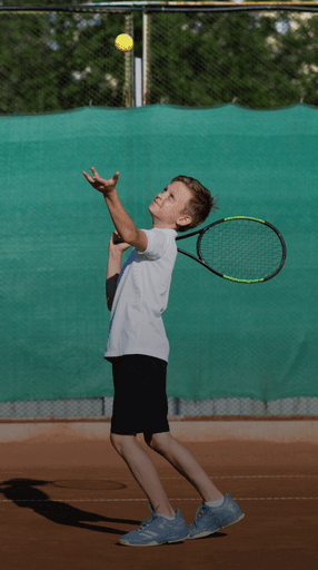 Young boy practicing tennis serve at a junior performance tennis camp available across Maryland and Virginia