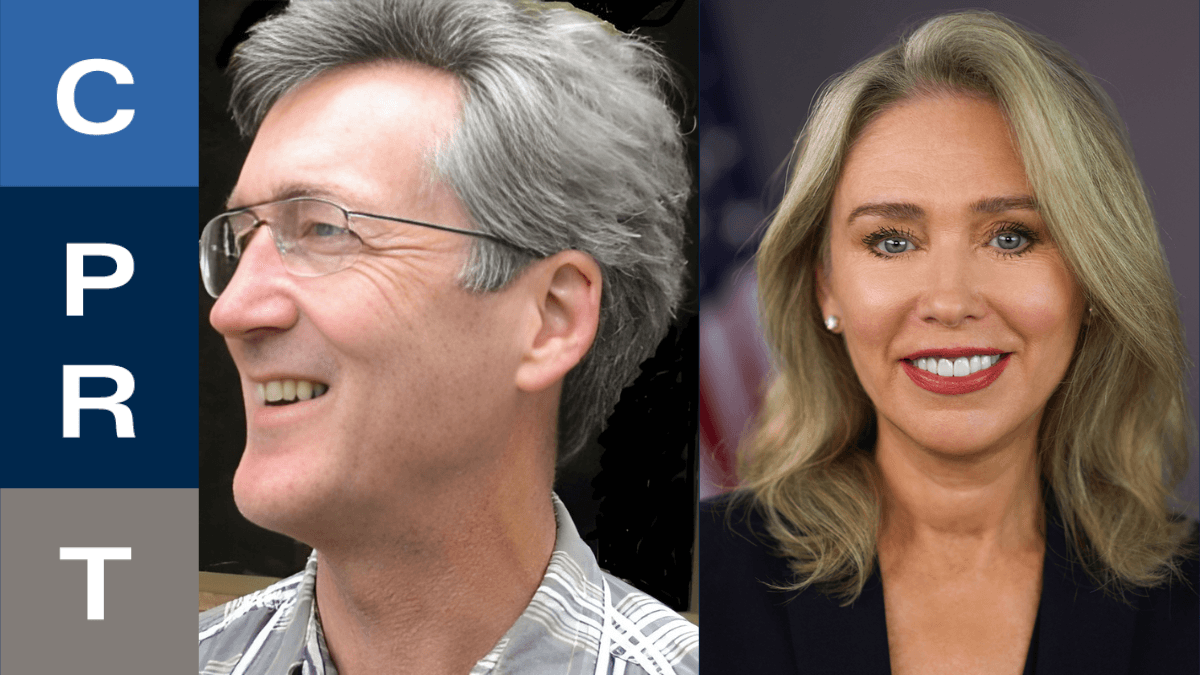 Two smiling individuals are shown side by side, with text elements on the left. A flag is in the background.