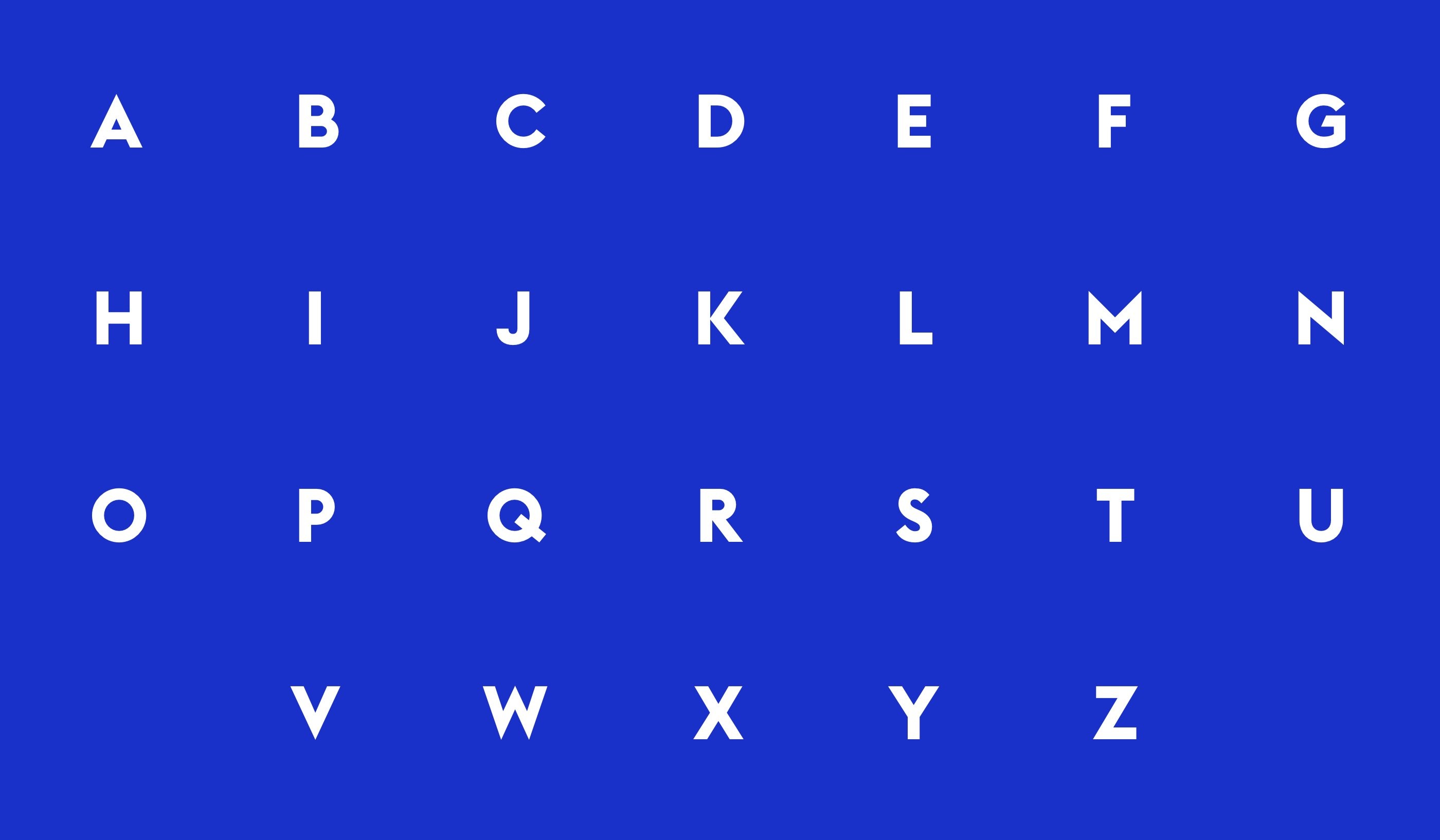Grid of the full alphabet in white capital letters on a bold blue background, part of the NEXT program's custom typeface specimen.